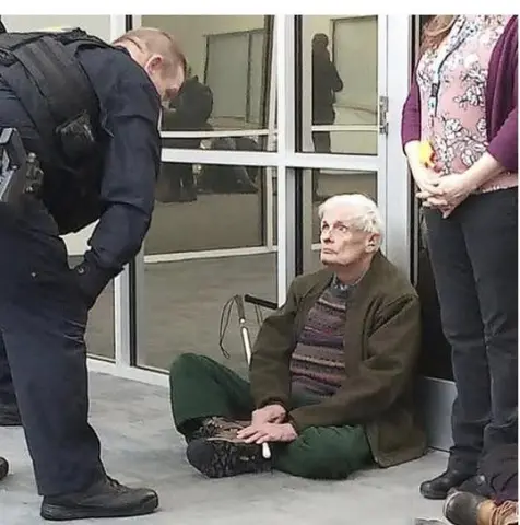 Vermont elder protesting at White Cap Business Park, home to ICE’s National Criminal Analysis and Targeting Center.